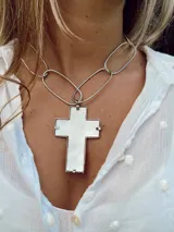 Collar plateado con cadena de eslabones grandes y dije de cruz de nácar con engarce plateado.