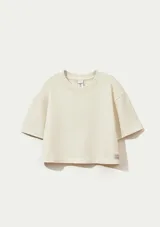 Blusa extragrande de tejido de punto en color beige, con cuello redondo y mangas cortas de corte holgado.