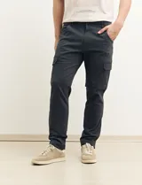 Pantalón de gabardina color marrón, corte slim fit, con bolsillos laterales tipo cargo.
