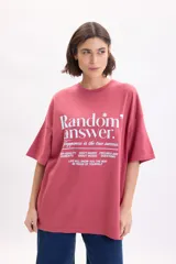 Remera de manga corta oversize color rojo, con cuello redondo y estampa frontal con texto en color blanco.