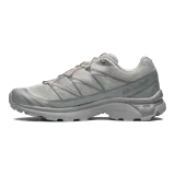 Championes Salomon XT-6, calzado de trail running adaptado para uso urbano. Diseño en color negro, gris, rojo y blanco, con sistema de cordones de ajuste rápido Quicklace y suela de gran tracción.