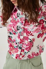 Camisa de manga larga con estampado abstracto en tonos marrones y blancos, cuello camisero y cierre frontal con botones. Puños con detalle de estampado animal print.