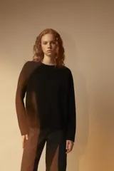 Sweater negro de punto con espalda abierta y mangas largas.