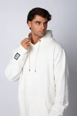 Buzo canguro oversize de tela friza, color negro, con capucha, cordones ajustables con logo y bolsillo frontal tipo canguro.