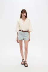 Short de jean de tiro alto con diseño de rayas verticales celestes y blancas, bolsillos laterales y vuelta en el ruedo.