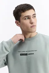 Buzo negro de algodón con cuello redondo, puños y cintura elásticos. Presenta un pequeño estampado frontal con texto en azul claro.