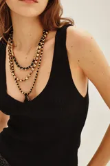 Musculosa de punto compacto, color blanco, con escote en V pronunciado y calce al cuerpo.