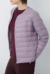Campera acolchada tipo puffer en color beige, con diseño sin cuello y cierre frontal con botones a presión.
