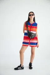 Riñonera negra de cuero vacuno con correa regulable, cierre superior con doble cremallera y bolsillo frontal con cremallera.