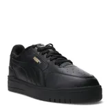 Championes urbanos Puma modelo Shuffle Downtown, de color negro con detalles en dorado. Presentan una capellada de cuero sintético con perforaciones en la puntera, cierre de cordones y suela de goma vulcanizada con tecnología SoftFoam+ para mayor amortiguación.