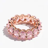 Anillo de acero con acabado en oro rosa, con cristales ovalados rosas engarzados en todo el contorno.