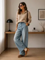 Botín tipo Chelsea de cuero metalizado en tono bronce, con paneles elásticos laterales en color beige. Presenta detalles de costuras decorativas tipo brogue en la puntera y laterales, con suela de goma antideslizante y taco bajo foliado.