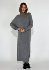 Vestido largo gris de tejido de punto con cuello alto y mangas largas.