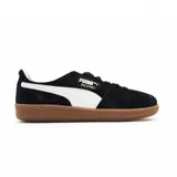 Championes Puma Palermo negros de gamuza con franja lateral blanca y suela de goma color caramelo.