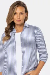 Camisa holgada de manga larga con estampado de rayas verticales en tonos azul y blanco, cuello camisero y cierre frontal con botones.