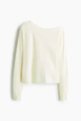 Buzo corto de punto fino en color crema, con diseño de un solo hombro y escote asimétrico. Presenta mangas largas y puños acanalados.