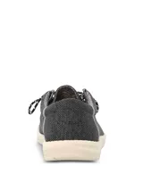 Alpargata Hush Puppies modelo Canyon, color negro con textura tejida. Presenta cordones jaspeados en blanco y negro, y suela de EVA en color crema.