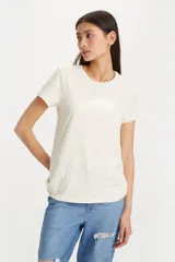 Remera de algodón color blanco hueso, con cuello redondo y mangas cortas. Presenta el logo de Levi's estampado en el frente con acabado metalizado.