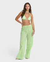 Pantalón tipo cover up de color verde menta, confeccionado en tela con diseño perforado o broderie. Posee cintura elástica con cordón de ajuste.