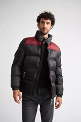 Campera puffer de nylon para hombre, con diseño bicolor en azul marino y mostaza en la parte superior. Cuenta con cierre frontal completo, mangas largas con puños elásticos y bolsillos laterales con cierre. Incluye logo estampado en el pecho.