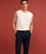 Pantalón de vestir azul marino, de corte relajado, confeccionado en tejido de viscosa y lino. Cuenta con cintura con trabillas, bolsillos laterales y traseros. Se ajusta a la cintura con cinturón de cuero marrón.