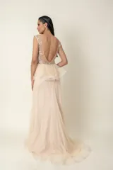 Vestido largo de fiesta color champagne, con corset de tul bordado con transparencias y falda de plumeti con cola.