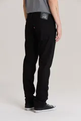Jean de corte slim fit en color negro, confeccionado en denim rígido. Presenta cierre de botón y cremallera, con diseño clásico de cinco bolsillos y tiro medio.
