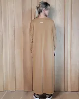 Vestido largo de lanilla en color gris melange, de corte holgado y diseño minimalista. Presenta cuello redondo, mangas largas y un bolsillo frontal tipo parche en el pecho.