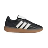 Championes urbanos Adidas modelo Barreda, color negro con las tres tiras laterales en blanco y suela de goma color caramelo. Presentan un diseño de inspiración clásica con lengüeta plegable y exterior en cuero sintético.