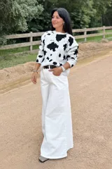 Jean de tiro alto con corte elefante, de color blanco y diseño holgado en las piernas.