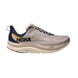 Championes de running Hoka Kawana 3, color beige con detalles en azul marino y amarillo, con suela amortiguada de gran volumen.