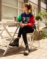 Borcego de gamuza color chocolate con paneles elásticos laterales negros y suela track de goma negra. Presenta cordones frontales con ganchos metálicos.