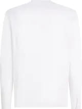 Camisa blanca de Tommy Hilfiger de corte slim fit, manga larga y cuello abotonado. Tiene el logo de la marca bordado en el pecho.