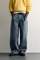 Jeans baggy fit de tiro medio, confeccionados en denim de algodón con efecto lavado. Presentan un diseño de cinco bolsillos, corte holgado y amplio en toda la pierna, con cierre frontal de botones.