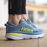 Championes de running Hoka Bondi 7, color celeste con detalles en amarillo y blanco.