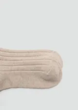 Calcetines de punto acanalado en color beige, con diseño clásico y textura suave.