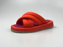 Sandalias de plataforma con diseño de tiras cruzadas acolchadas en color verde y plantilla en color naranja.
