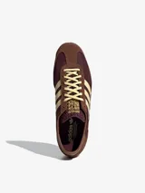 Zapatillas Adidas modelo SL 72 OG, con diseño retro de caña baja. Presentan un empeine de nailon en tono bordó con refuerzos de gamuza en color marrón, icónicas tres tiras laterales en color crema y detalles en piel. Incluyen una mediasuela de EVA con una franja azul y suela de goma dentada.