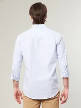 Camisa celeste a rayas verticales finas, de manga larga y corte clásico.