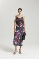 Pollera midi al bies confeccionada en cupro con cierre invisible y detalle de vivo en la cintura.