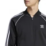 Campera deportiva Adidas Adicolor Classics negra con cierre frontal, cuello alto y tres rayas blancas en las mangas.