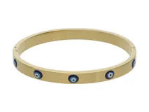 Pulsera rígida dorada con diseño de cinco ojos turcos azules y blancos.