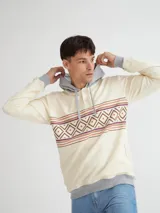 Canguro color crema con capucha gris, media cartera de botones y arte estampado en franja con motivos geométricos.