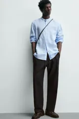 Pantalón de corte relajado confeccionado en una mezcla de algodón y lino. Presenta cintura elástica con cordón ajustable, bolsillos laterales y bolsillos traseros de vivo.