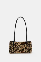 Bolso de hombro de piel con textura y estampado animal print, con doble asa larga negra y compartimento interior con cremallera.