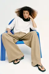 Jeans de tiro alto con pinzas delanteras, pernera ancha y fluida. Cuenta con cierre frontal de cremallera y botón, bolsillos frontales y bolsillos de plastrón en la parte trasera.