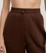 Pantalón deportivo tipo jogger de la marca Get Over, confeccionado en una mezcla de poliéster, modal y elastano. Presenta cintura elástica con cordón de ajuste, bolsillos delanteros amplios y puños elásticos en los tobillos.