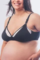 Soutien maternal sin aro, confeccionado en algodón negro con detalles de puntilla blanca en los bordes. Cuenta con clip de apertura en los breteles para lactancia, breteles elásticos regulables y cierre de broches en la espalda.