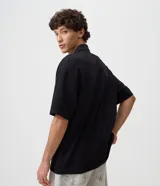 Remera de algodón para hombre con diseño boxy, cuello polo y escote en V. Presenta mangas cortas y estampas localizadas en el frente, incluyendo la frase 'Join the Hype'.