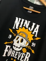 Remera negra con estampado de calavera con vincha de Naruto y texto "Ninja Forever" con los números 19 y 99.
